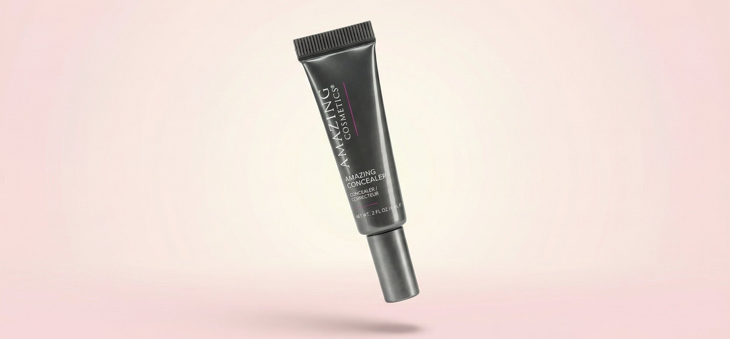 Cosmetic tube on a pink gradient background