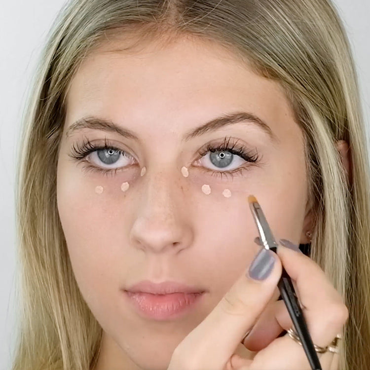 model using concealer brush