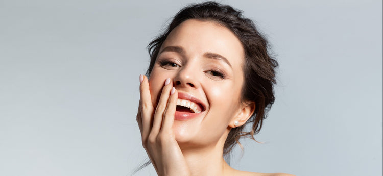 Woman with a bright smile against a plain background