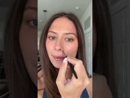Model applying AMAZINGCONCEALER over blemishes, redness and dark circles using it to spot correct.